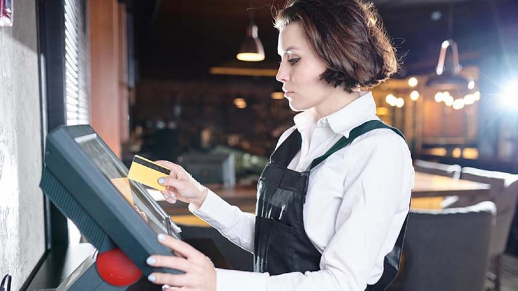 Waitress using a POS Terminal