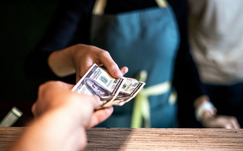 A business owner using a cash discount program to save money on credit card processing fees