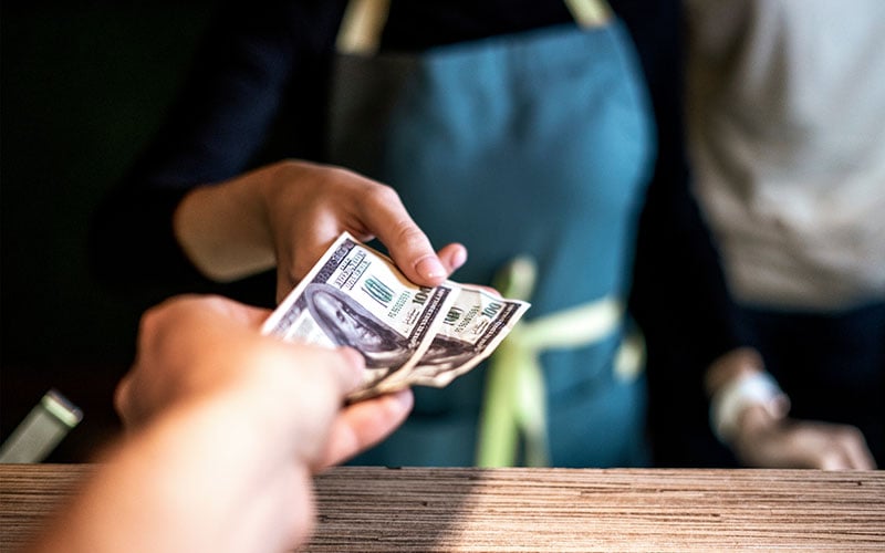 A business owner using a cash discount program to save money on credit card processing fees