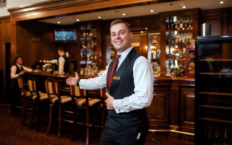 Server Welcoming Restaurant Guest