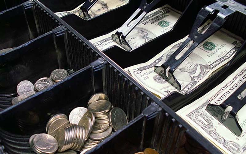 Cashier balancing the register drawer at shift’s end