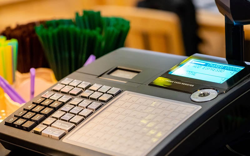 Cashier setting up a register