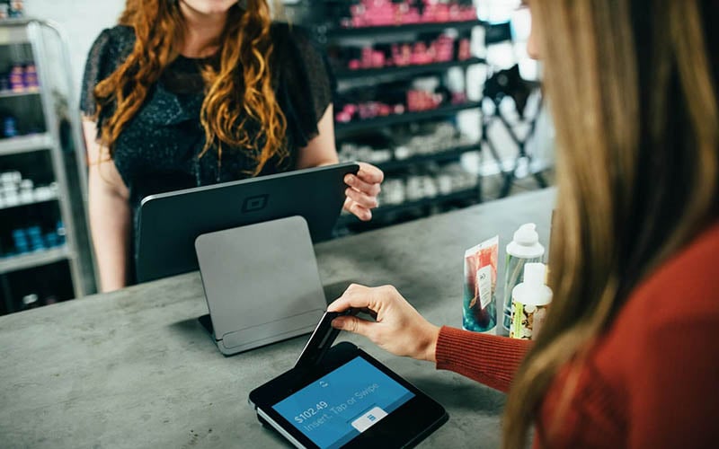 Cashier accepting payments a the register